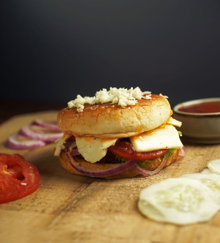 Tasty paneer burger topped with fresh ingredients, perfect for a quick meal.
